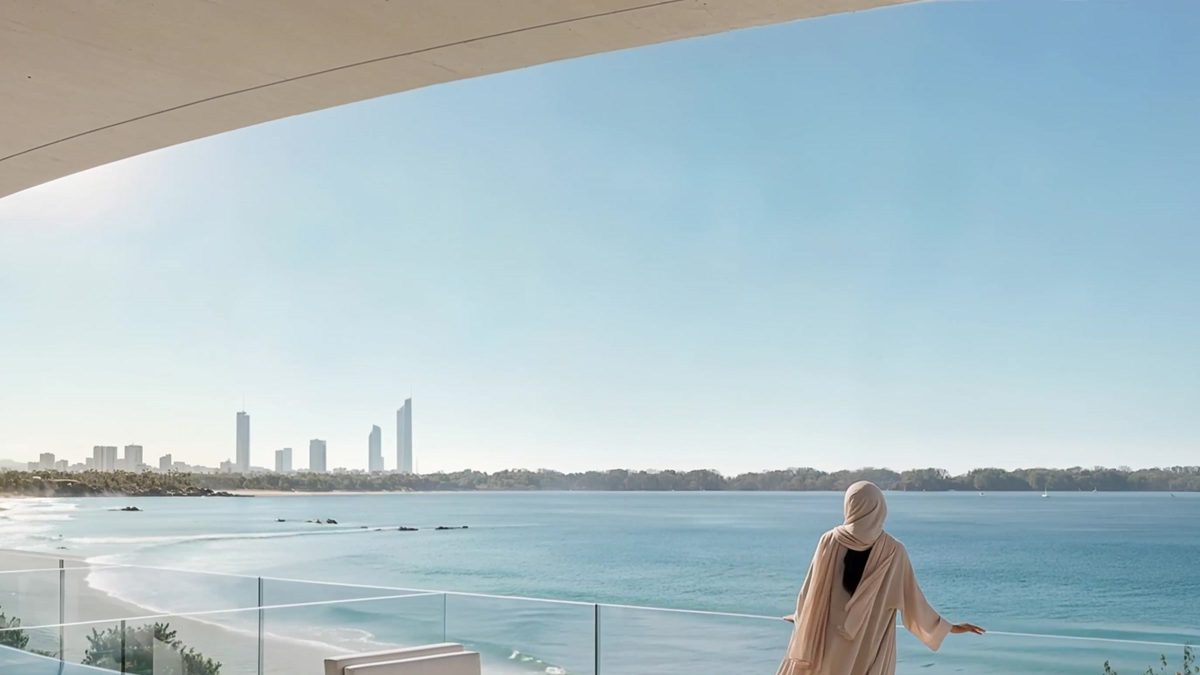 A terrace above the sea, a woman at the glass balustrade and the city skyline on the horizon
